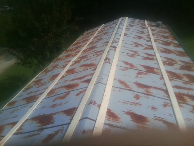 Rusted metal roof panels with new wood purlins before replacement — Storm Damage Roof Repair in Bearcreek by Roofing Brothers